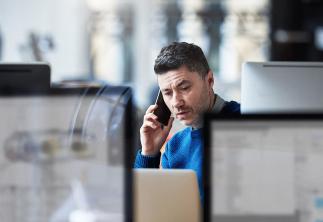 Man on his mobile phone in office