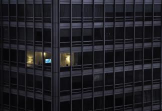 Office block with all lights off apart from one office