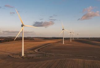 Wind Turbines in a field with the sun setting