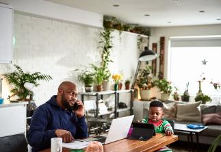 Dad and son working on kitchen table