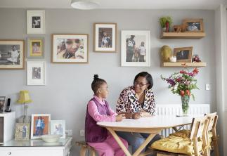 Mum and daughter doing homework in their kitchen