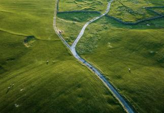 Single track country road through fields photo taken from above