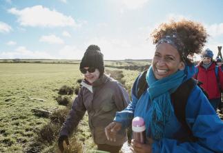 people laughing whilst doing a country walk