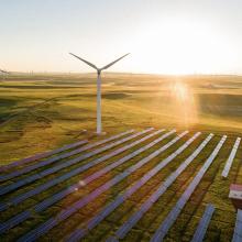 Turbine and solar panels with bright sunlight