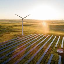 Turbine and solar panels with bright sunlight