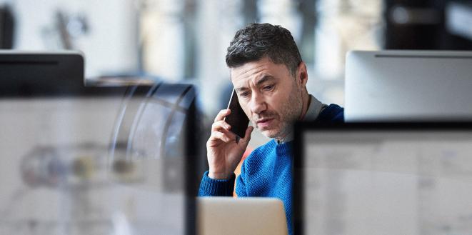 Man on his mobile phone in office