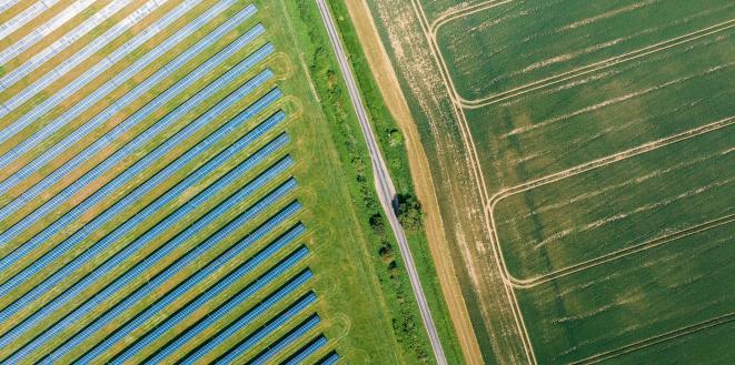 Solar panels on left side of field and right side is farmers field