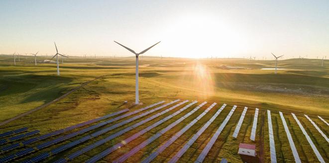 Turbine and solar panels with bright sunlight