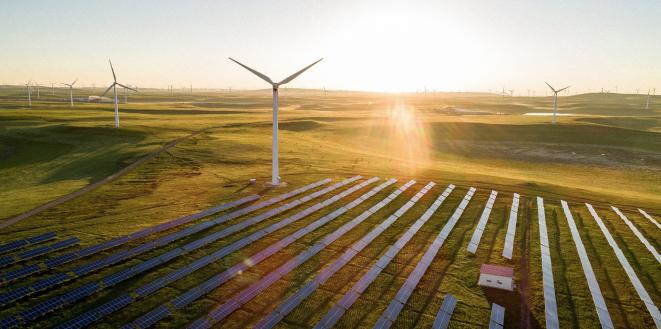 Turbine and solar panels with bright sunlight