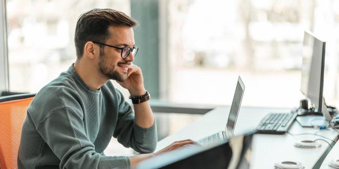 smiling man at laptop