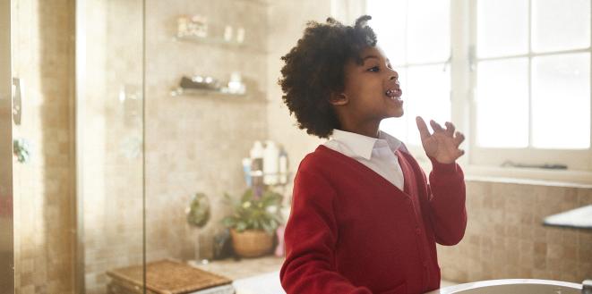 Child brushing their teeth in the bathroom