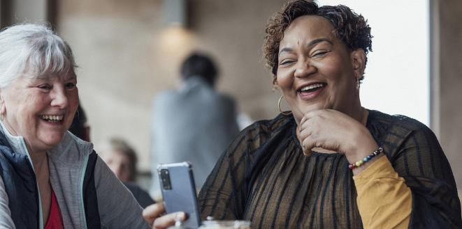 Friends laughing at something on their phone