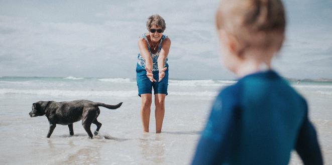 Mum and son at beach with dog