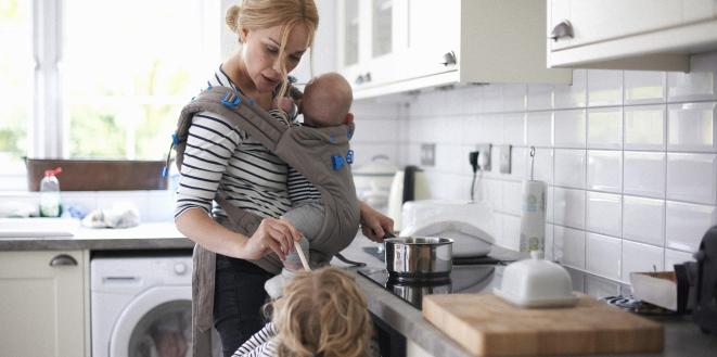 lady with children making dinner in kitchen