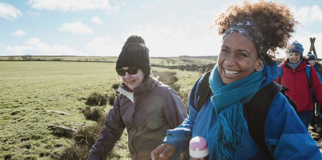 people laughing whilst doing a country walk