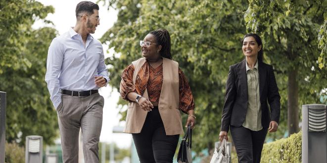 team members walking having a conversation looking happy