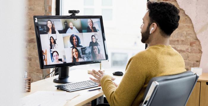 Gentleman working on desktop during a team meeting with team mates