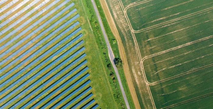 Solar panels on left side of field and right side is farmers field