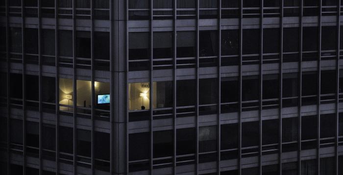 Office block with all lights off apart from one office