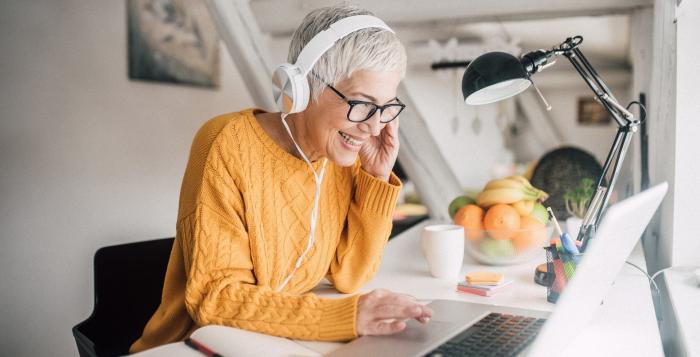 Smiling lady working at laptop