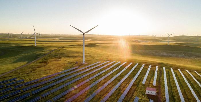 Turbine and solar panels with bright sunlight