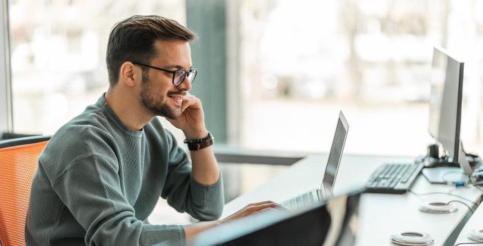 smiling man at laptop