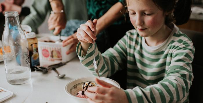 Child staring intently at icecream