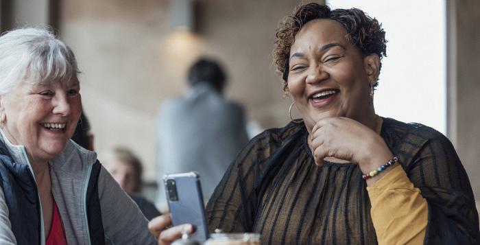 Friends laughing at something on their phone