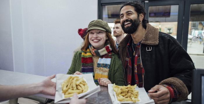 Happy couple Ordering fish and chips