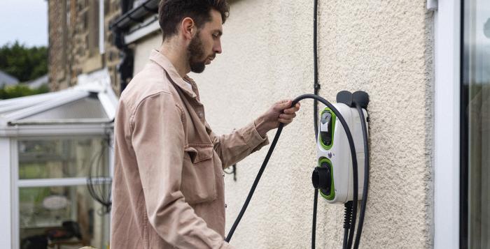 Man tidying up his electric charging wire