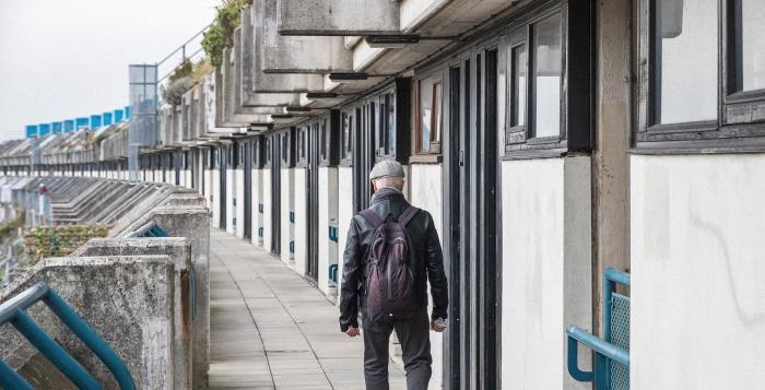 Man walking on his own with backpack on