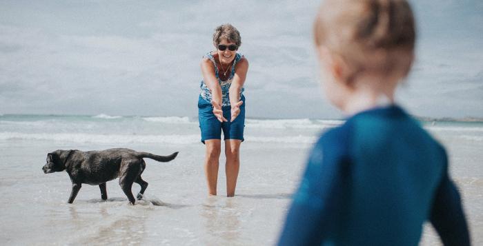 Mum and son at beach with dog