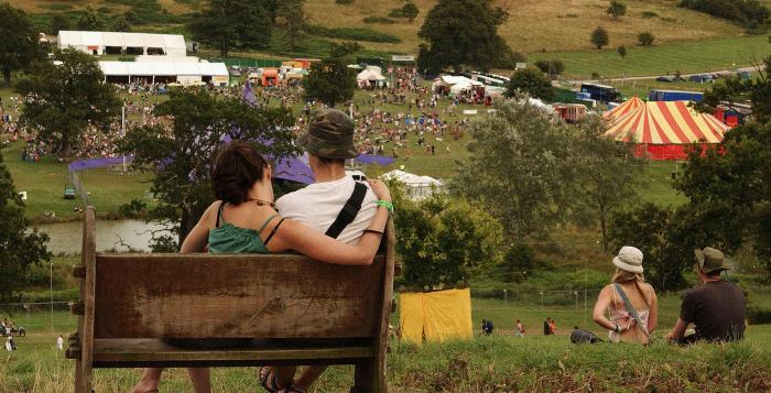 People sat on a bench at a festival