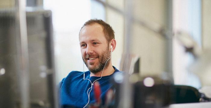 Person sat workiong with ear phones in