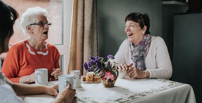 group of older ladies looking happy having a conversation